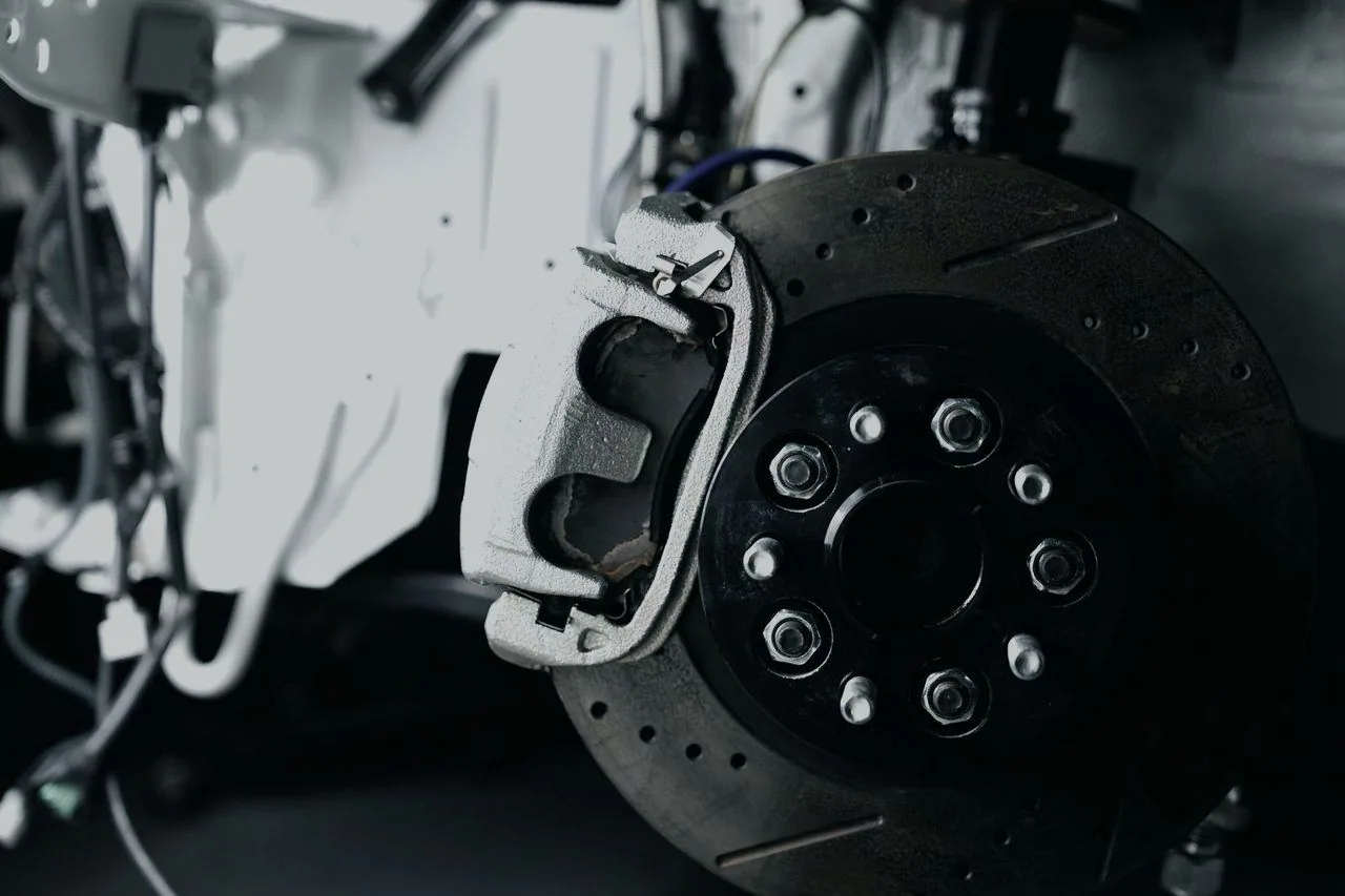 A vented brake disc and caliper removed from a wheel hub