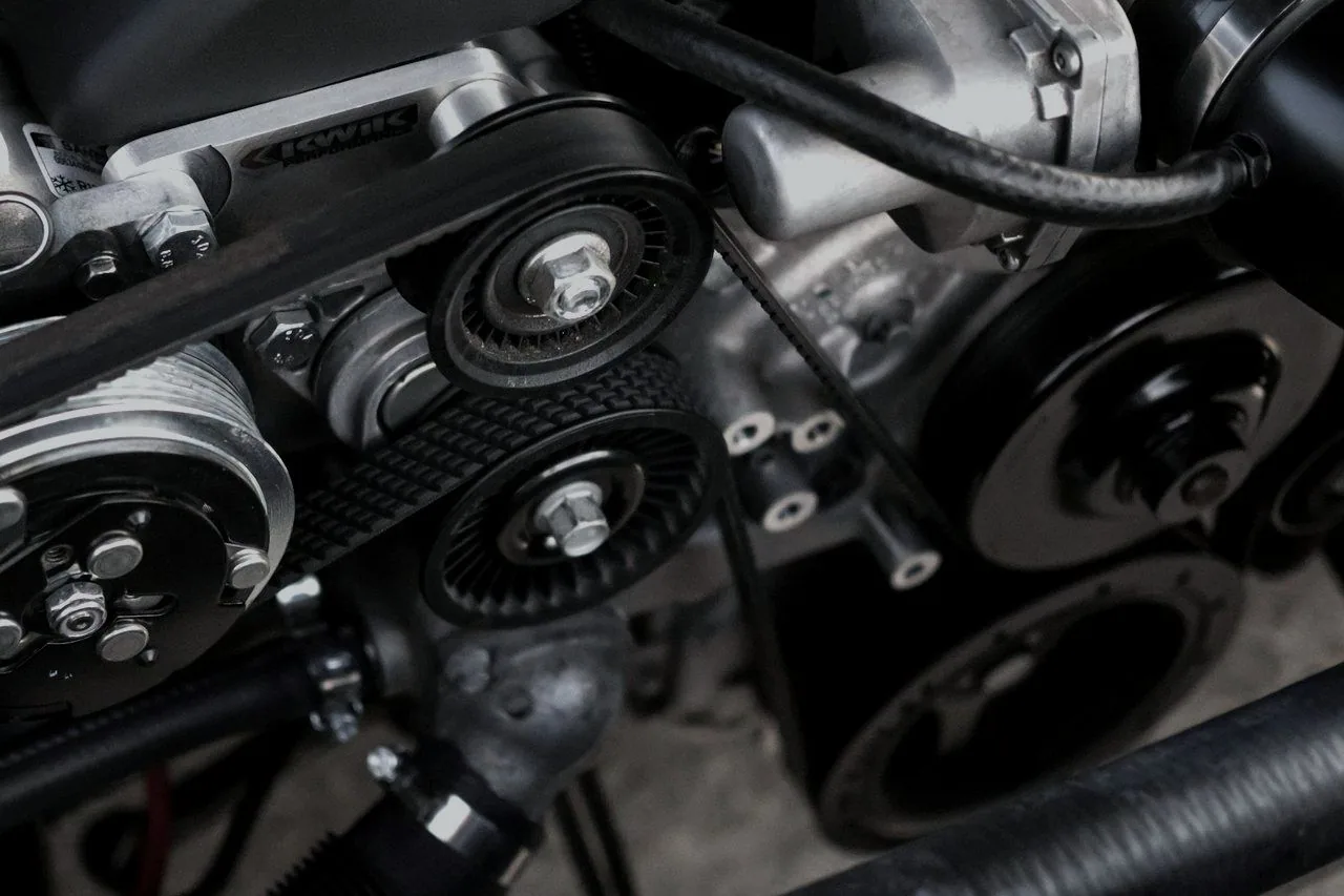Close-up of an engine’s belts, pulleys and tensioner
